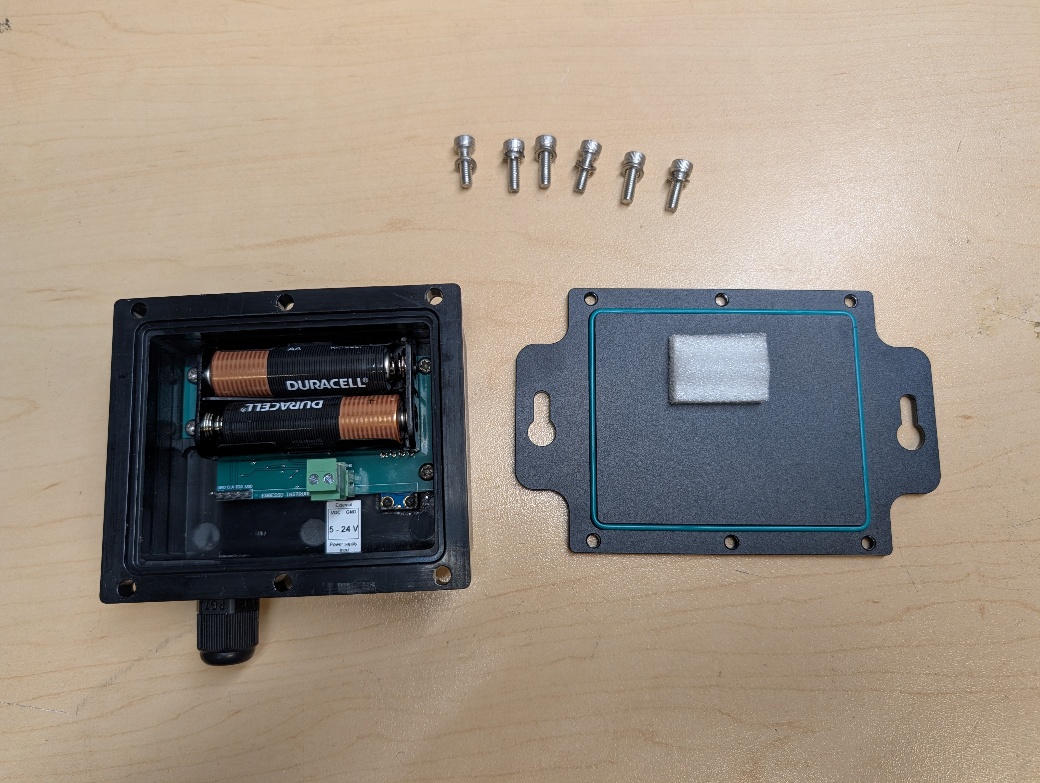 EPH-T70 sensor disassembled: sensor body with battery holder (left) and base plate (right)